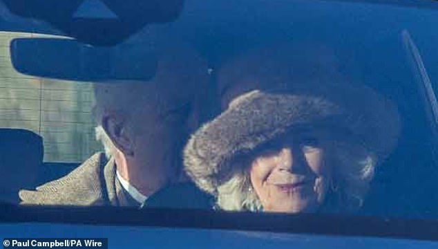 Sitting in the front passenger seat and showcasing a radiant smile, the Queen put on a stylish display in a fur hat