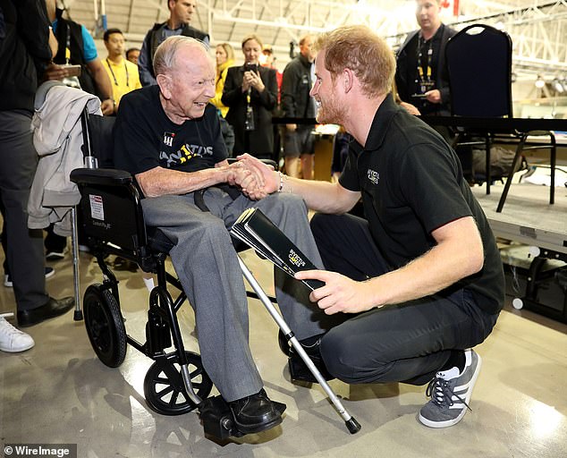 Prince Harry shakes hands with 102-year-old WW2 veteran Norm Baker at the Invictus Games in Toronto in 2017