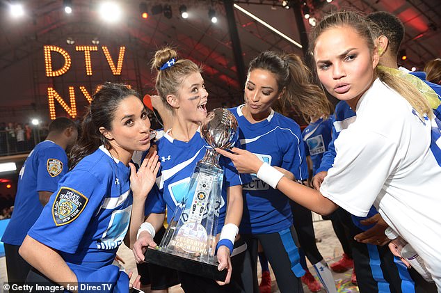 Chrissy Teigen is pictured together with Meghan Markle in 2014 for the DirecTV Beach Bowl at Pier 40