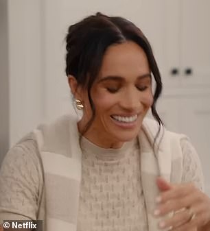 Meghan draped a cashmere a $395 cashmere jumper from Jennie Kayne around her shoulders in another scene