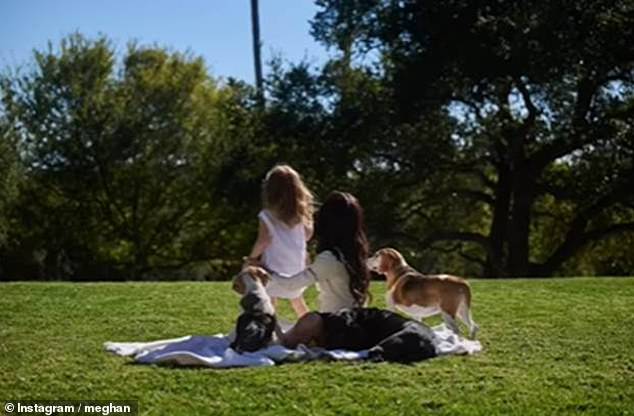 In another clip Meghan and Lilibet are seen having a picnic with the pooches