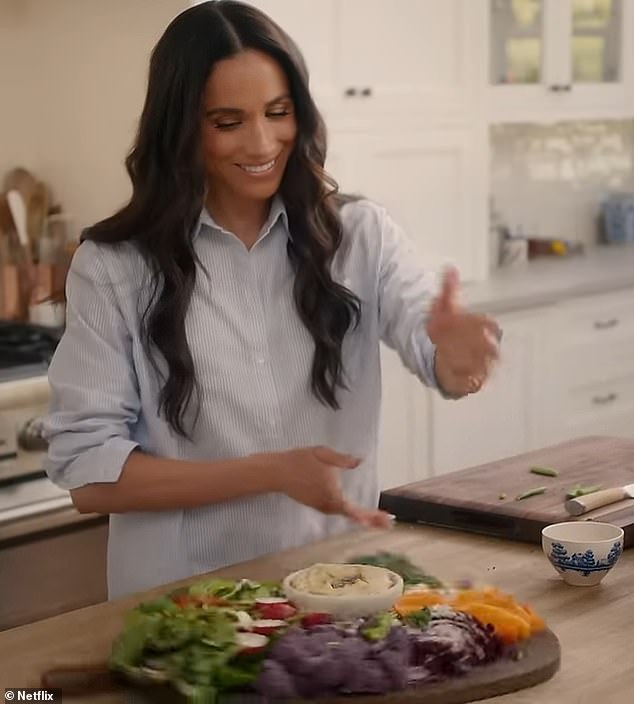 The Duchess of Sussex puts the finishing touches to a salad board, featuring an array of items