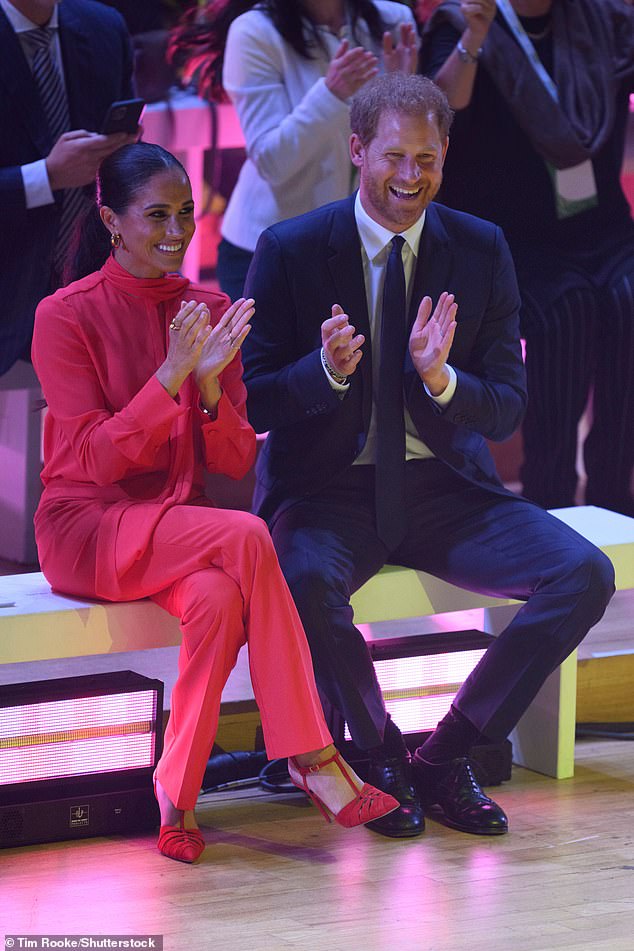 Meghan looked resplendent in red Another Tomorrow separates for the 2022 One Young World summit, completing the ensemble with matching £730 red suede Panthere pumps