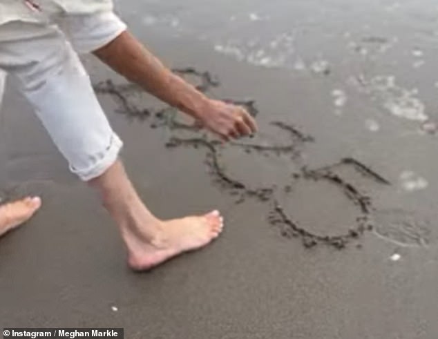 She then wrote '2025' in the sand, before she turned and grinned at the camera before running off