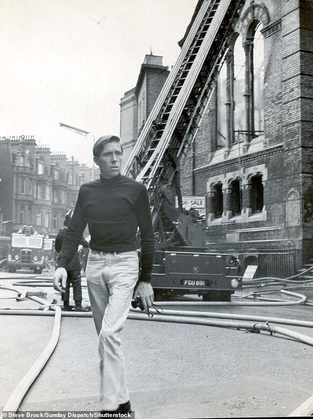 Lord Snowdon, pictured carrying a camera in Sloane Street, London back in 1959