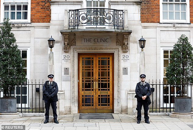 Police officers stand outside The London Clinic where Kate and the King stayed after surgery