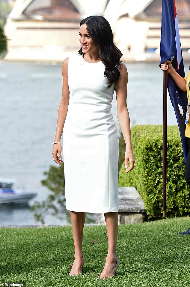 On the first day of her tour of Australia with Harry, Meghan wore a sleek ivory dress by local designer Karen Gee. Named 'Blessed,' the £973 dress made headlines as Meghan had just announced her pregnancy