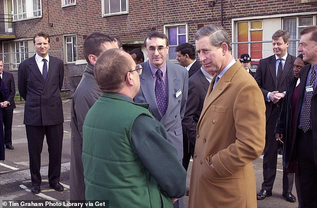 Mark Bolland (far left with hands behind back) watches over Charles as he visits Naish Court Housing Estate in London