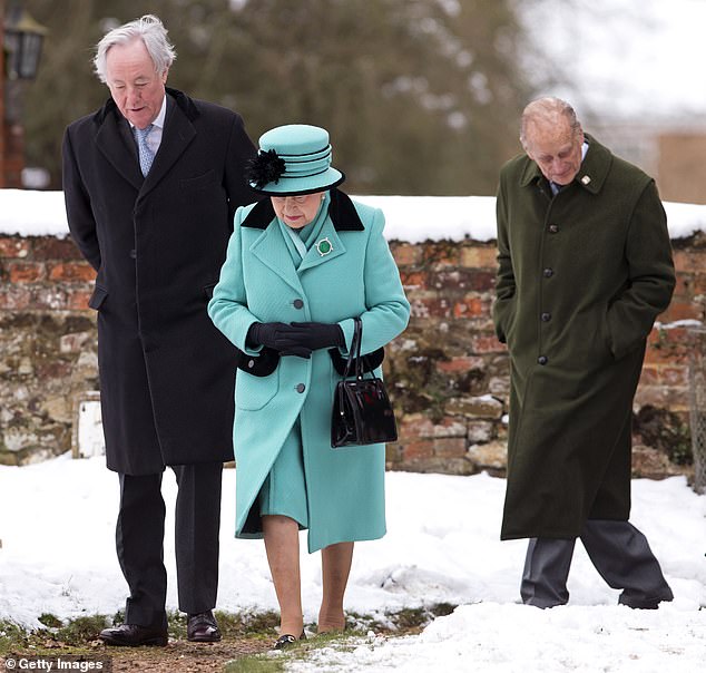 Queen Elizabeth II and Prince Philip walk through the snow-covered church yard to attend Sunday Service at the Church of St Lawrence in Castle Rising near the Sandringham Estate on January 20, 2013