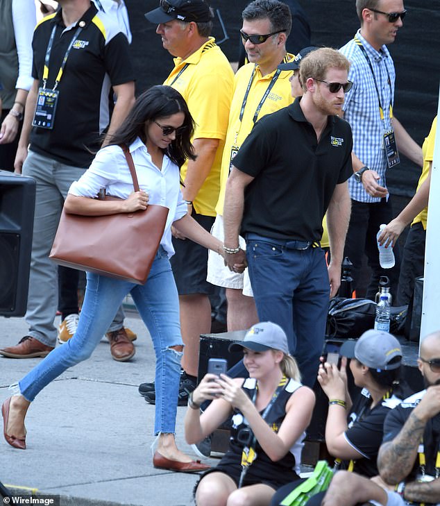 Meghan and Harry holding hands at the Invictus Games event in Toronto