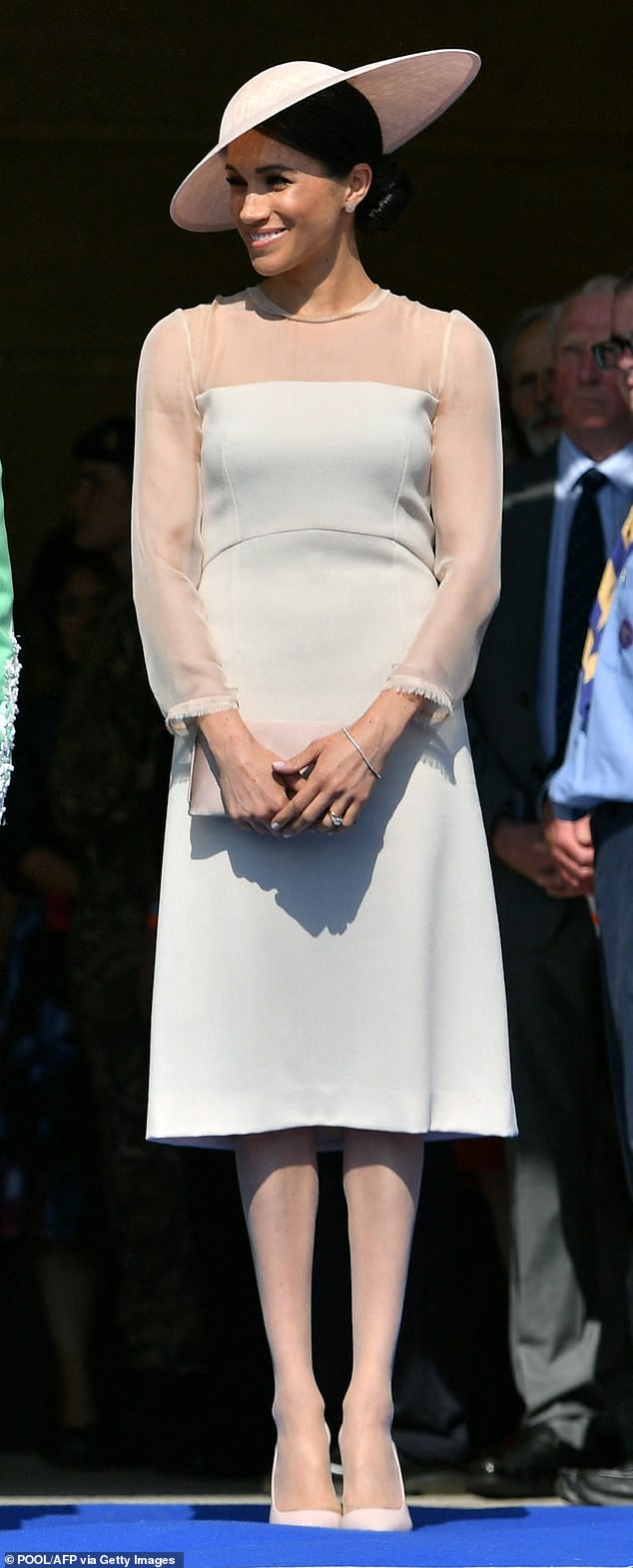 Meghan attended Prince Charles's 70th birthday patronage celebrations in a blush-toned outfit, topped with a Philip Treacy saucer-style hat