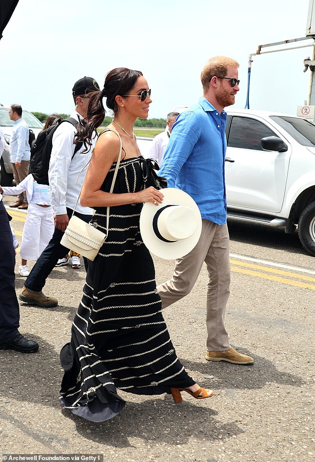 Meghan Markle is pictured with Prince Harry during their to Colombia last August. She is seen sporting a handbag from Cesta Collective, a 'mission-based' Rwandan brand she has invested in