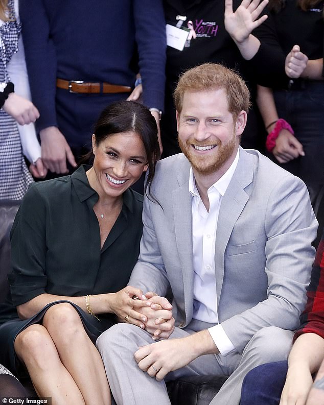 This picture in October 2019 was one of the first times Meghan showcases her habit of holding one of Harry's hands with both of hers - dubbed the 'hand sandwich' by body language experts