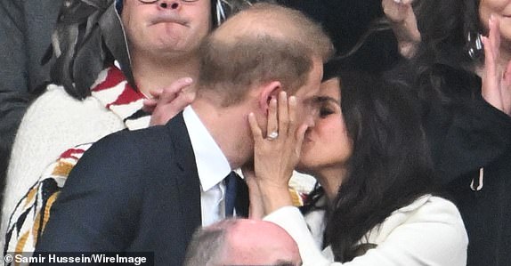 WHISTLER, BRITISH COLUMBIA - FEBRUARY 08: Prince Harry, Duke of Sussex and Meghan, Duchess of Sussex kiss during the opening ceremony of the 2025 Invictus Games at BC Place on February 08, 2025 in Whistler, British Columbia.  (Photo by Samir Hussein/Samir Hussein/WireImage)