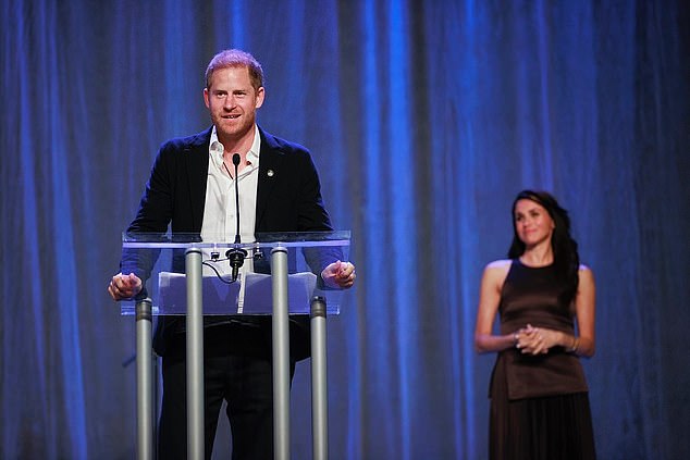 Meghan Markle has been spotted adoringly watching her husband Prince Harry as he opened the seventh edition of the Invictus Games