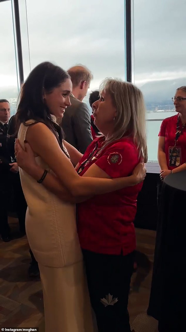 Meghan hugs a woman as she and Prince Harry meet with competitors ahead of the games