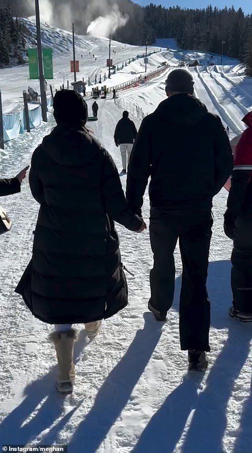 In her last appearance before leaving the event to fly home to California , Meghan is also filmed walking hand-in-hand with her husband to the start of the tubing run