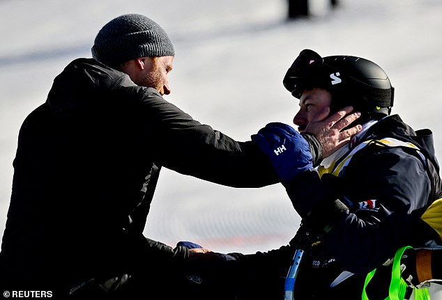 Prince Harry greets sit ski athlete Neil Fellingham at the finals of the alpine skiing novice competition at Whistler