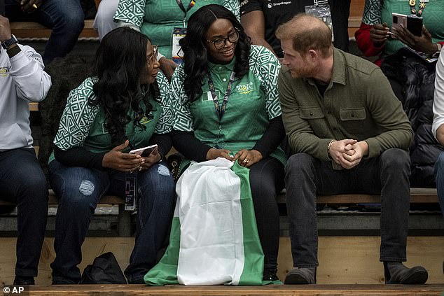 Prince Harry, the Duke of Sussex, talks with friends and family of Team Nigeria while watching Sitting Volleyball at the 2025 Invictus Games