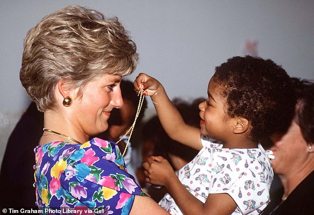 Though they prefaced that they didn't mean it 'in a critical way', the insider added that the former royal had wanted follow in the footsteps of her late mother-in-law, who was known for her extensive humanitarian and charity work (Diana pictured holding a baby in a hostel in Brazil)