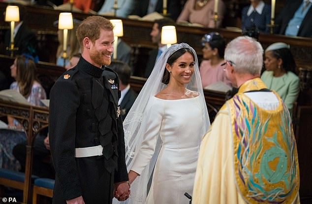 The Duke and Duchess smile at the then Archbishop of Canterbury Justin Welby, who they claim married them three days prior to the public wedding ceremony