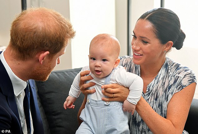 The Duke and Duchess of Sussex hold their son Archie in June 2020 - before he was made prince as per King George V's written order