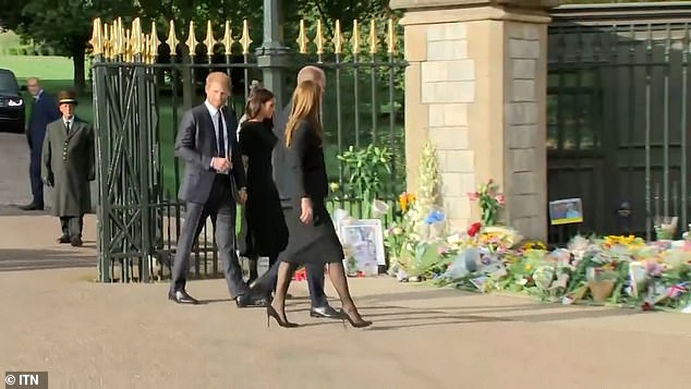 As they turned past the gate of Windsor Castle, Harry appeared to strategically slow down his walk while subtly using his hand to guide Meghan back into place