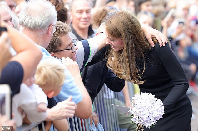 The Princess of Wales hugging a man over the barriers