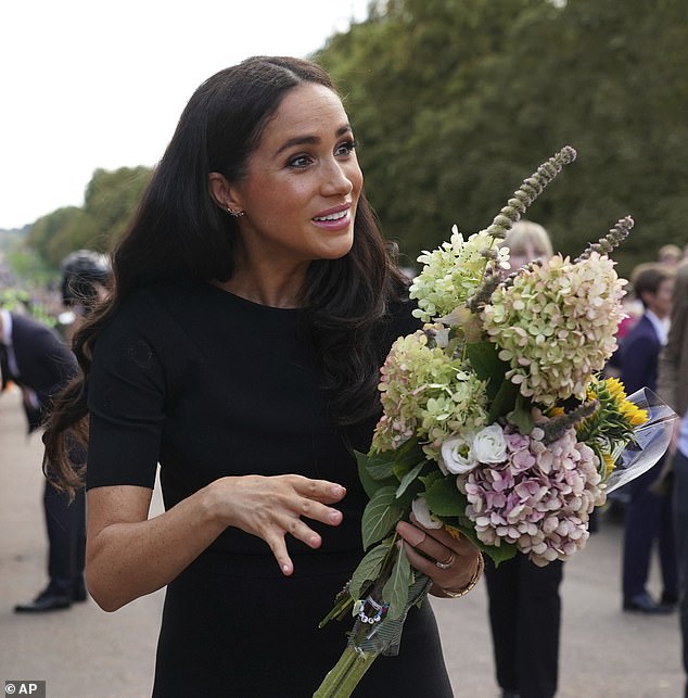 Meghan was given flowers when she stopped to chat to the mourners