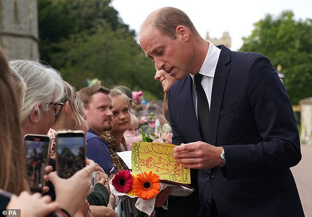 William diligently looks over a card drawn up by a young royal fan