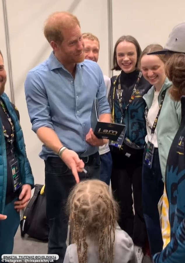 Prince Harry beamed as he realised that an adorable little girl who was asking for his autograph was the daughter of a Team Ukraine player at the Invictus Games in Canada