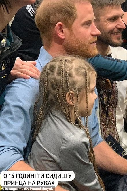 The royal hugged his young fan in a sweet snap, as he posed for photos with supporters at the Games