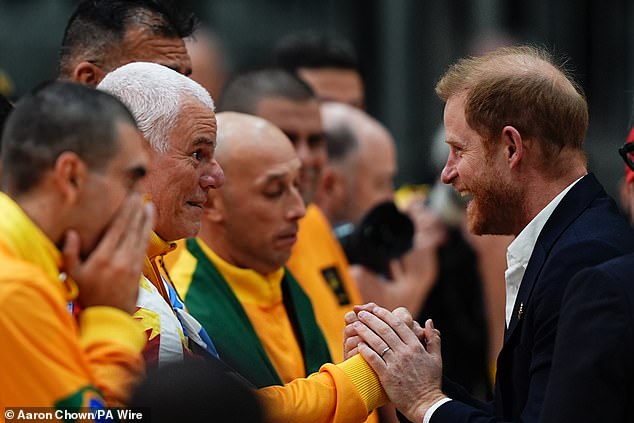 Harry shakes hands with sportspeople during the sitting volleyball final this weekend