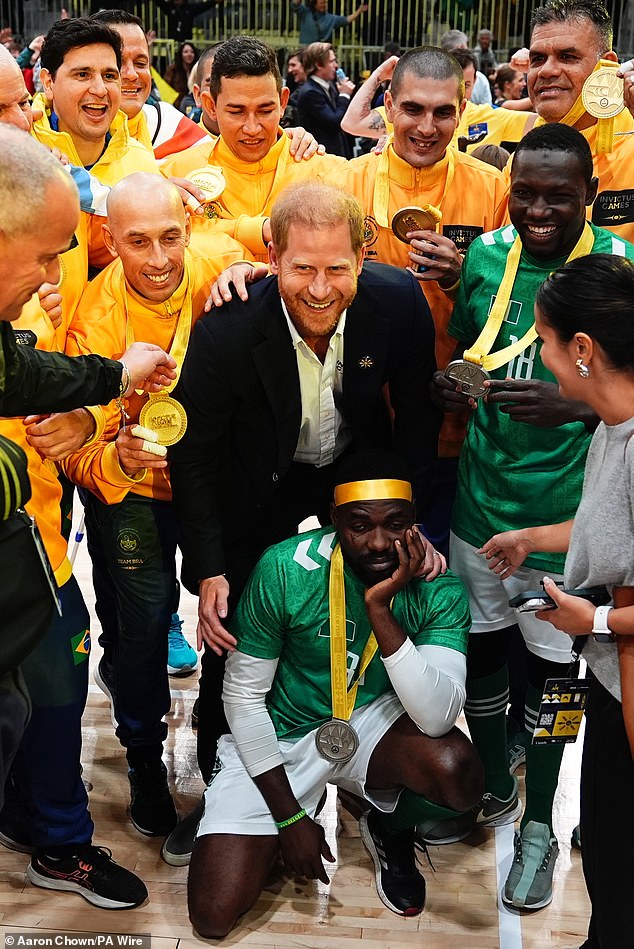 Harry looks elated as he poses for photos at Saturday's celebrations in Vancouver