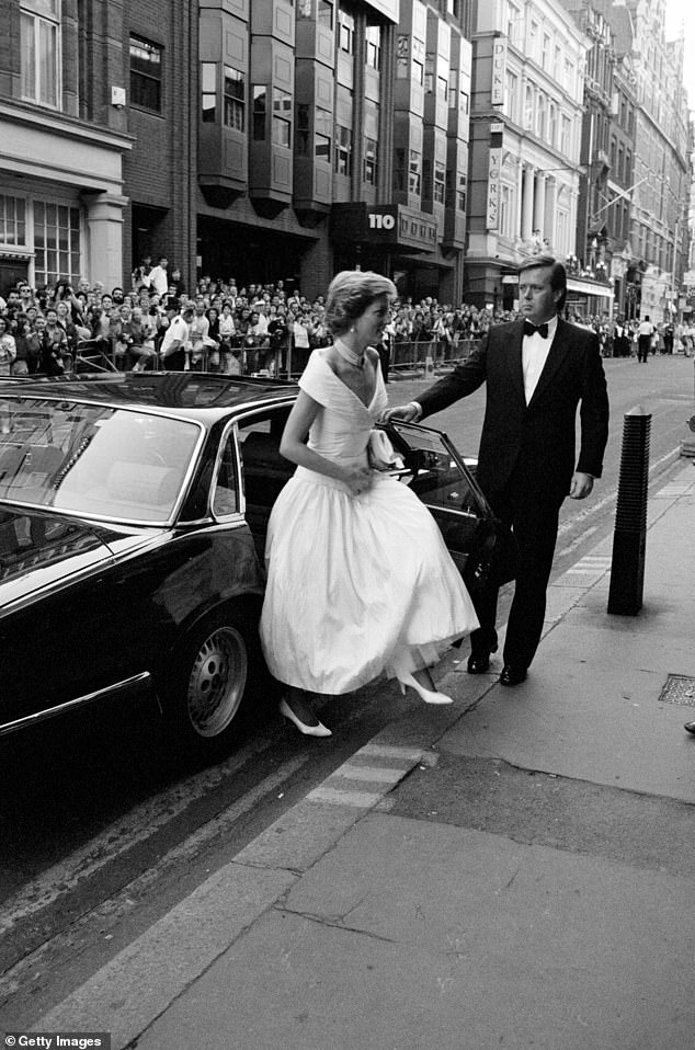 A royal protection officer holds the door open for Princess Diana to attend the ballet in London in July 1988