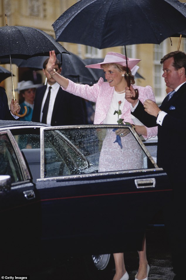 The bodyguard holds an umbrella for the Princess of Wales in June 1989 - after opening and closing the car door in Northampton