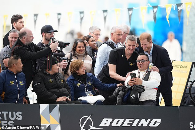 Despite being so far from his wife, who chose to head back to California early to be with their two children, Harry was spotted happily posing for selfies and joking with supporters of the South Korean and Danish teams.