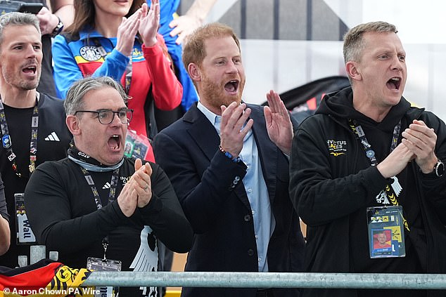 Prince Harry is all smiles and laughter as he shushes fans at the Invictus Games, despite Meghan being 1000 miles away on Valentine's Day