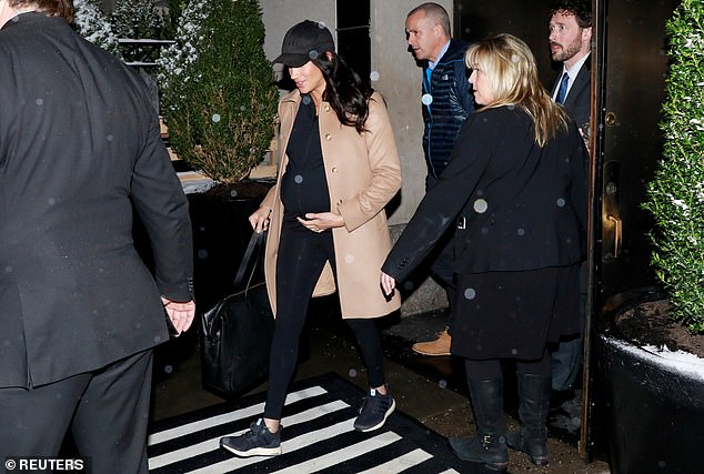 When Meghan used the side door to leave, she was snapped by the horde of photographers waiting for her outside