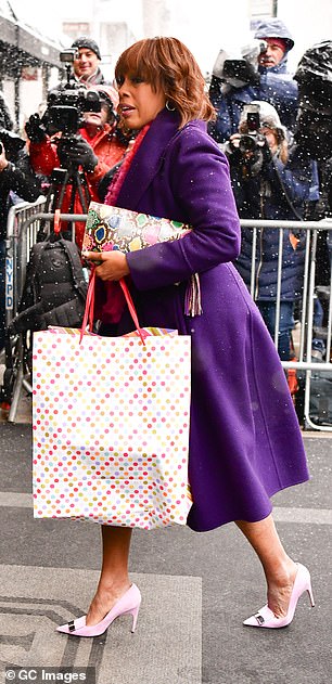 CBS News host Gayle King walks past photographers on her way to the baby shower