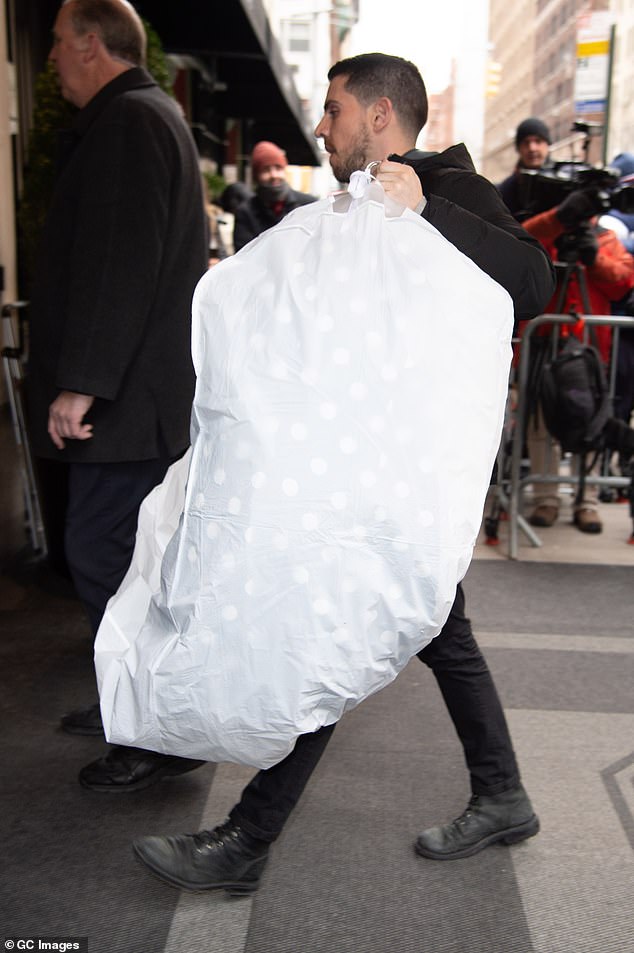 One worker was seen carrying a dress carrier inside the event as the celebrities gathered