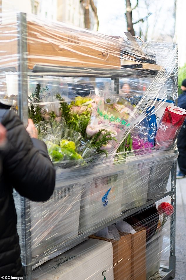 Workers were seen delivering trolleys full of flowers and other packages for the event