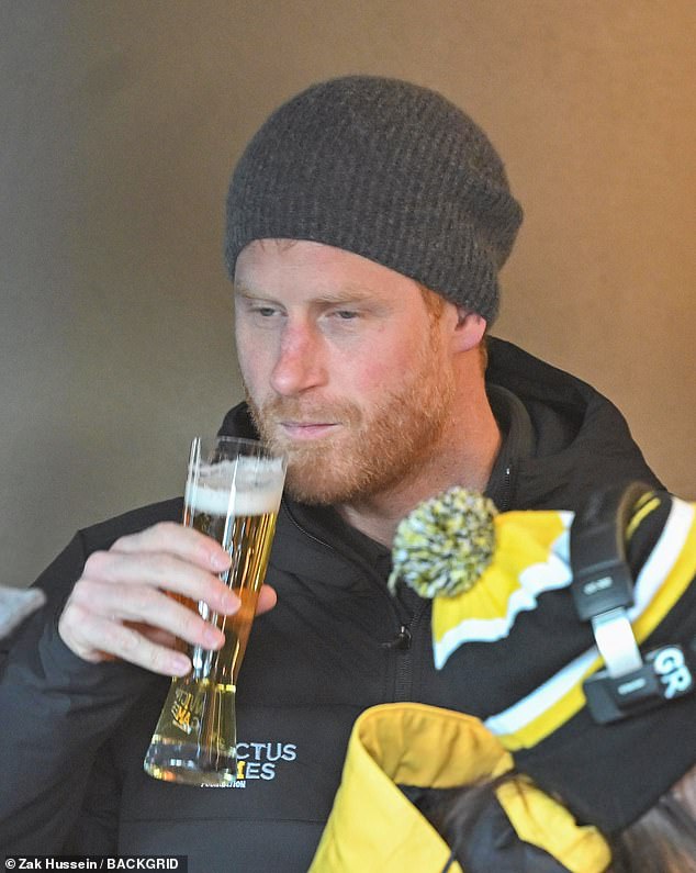 Prior to opening the Invictus Games in a popular ski resort Harry could be seen stamping his feet to keep warm as he and Meghan waited in a restaurant. Pictured: Harry enjoys a beer