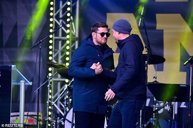 Prince Harry and Michael Buble hold hands onstage at the Whistler Welcome Celebration