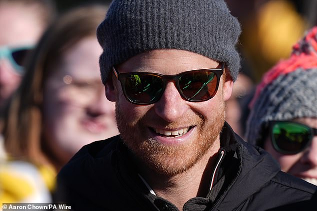 Harry is pictured beaming earlier today at the Alpine Skiing and Snowboarding Novice Finals