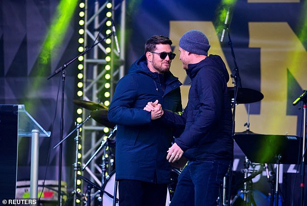 Pictured: Prince Harry and Michael Buble shake hands onstage at the Whistler Welcome Celebration