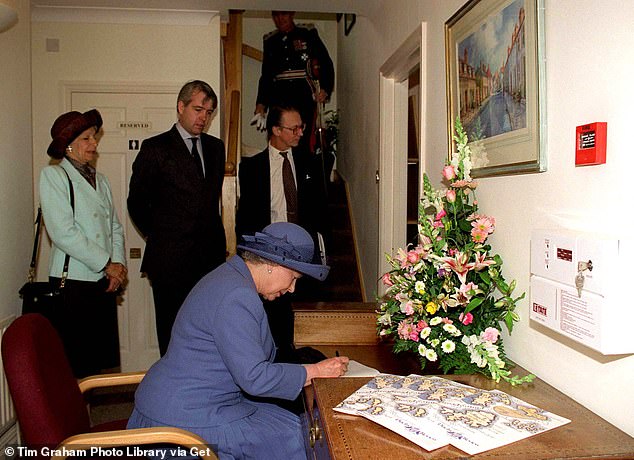 The late Queen visiting Poundbury in Dorset in May 1998. Sir Robert Fellowes is standing in the background