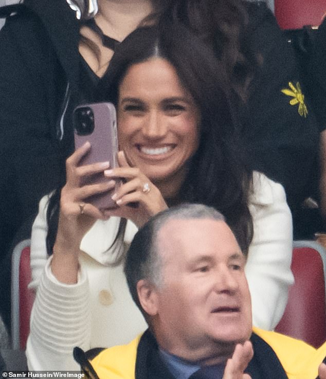 She wore a yellow gold 'Tank Française' Cartier watch, a yellow gold 'Love' Bangle as well as several other stacked bracelets and a pinky signet ring