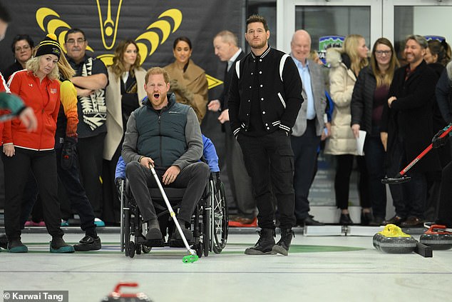 Harry and Meghan visited Vancouver in February last year to promote the Invictus Games and were joined by Buble and his wife (back left) at a curling event held in the Hillcrest Centre (pictured)