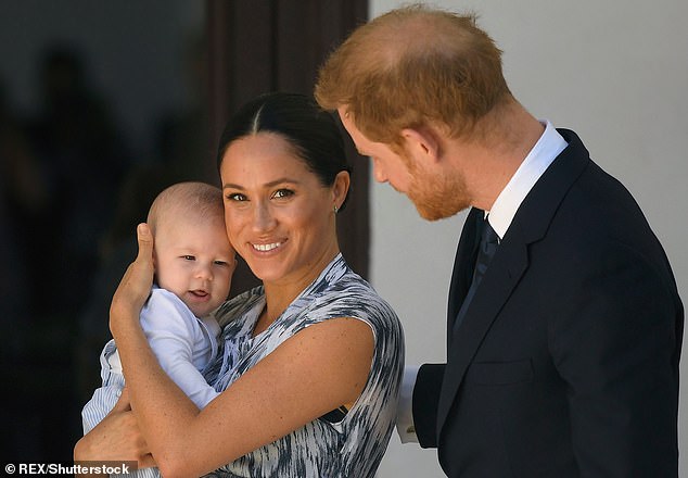 Prince Harry and Meghan Duchess of Sussex, holding their son Archie Harrison Mountbatten-Windsor in 2019